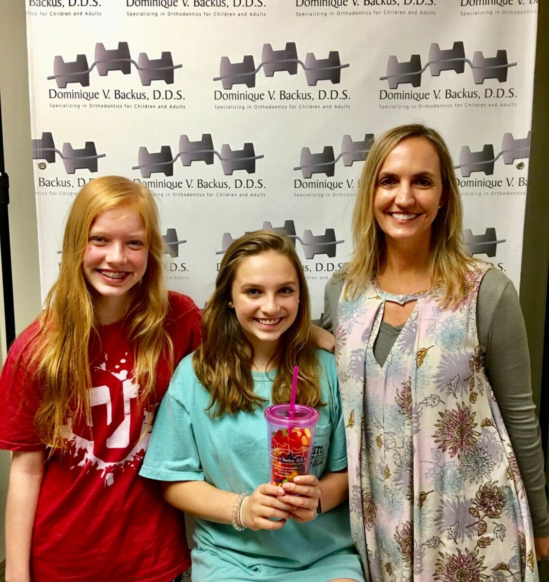 Dr. Backus with two girl patients, Backus Smiles