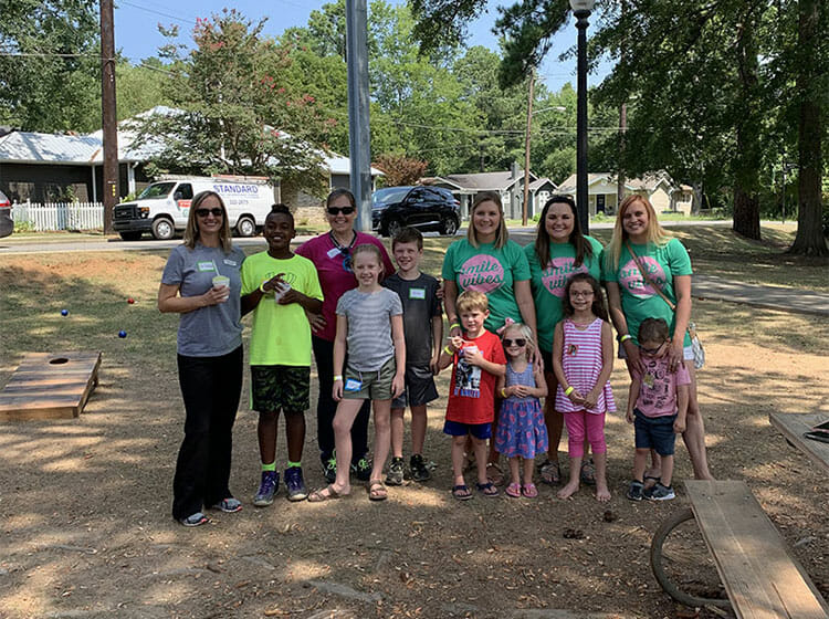 Dr. Backus and some of her team members doing charity work in the community, Backus Smiles