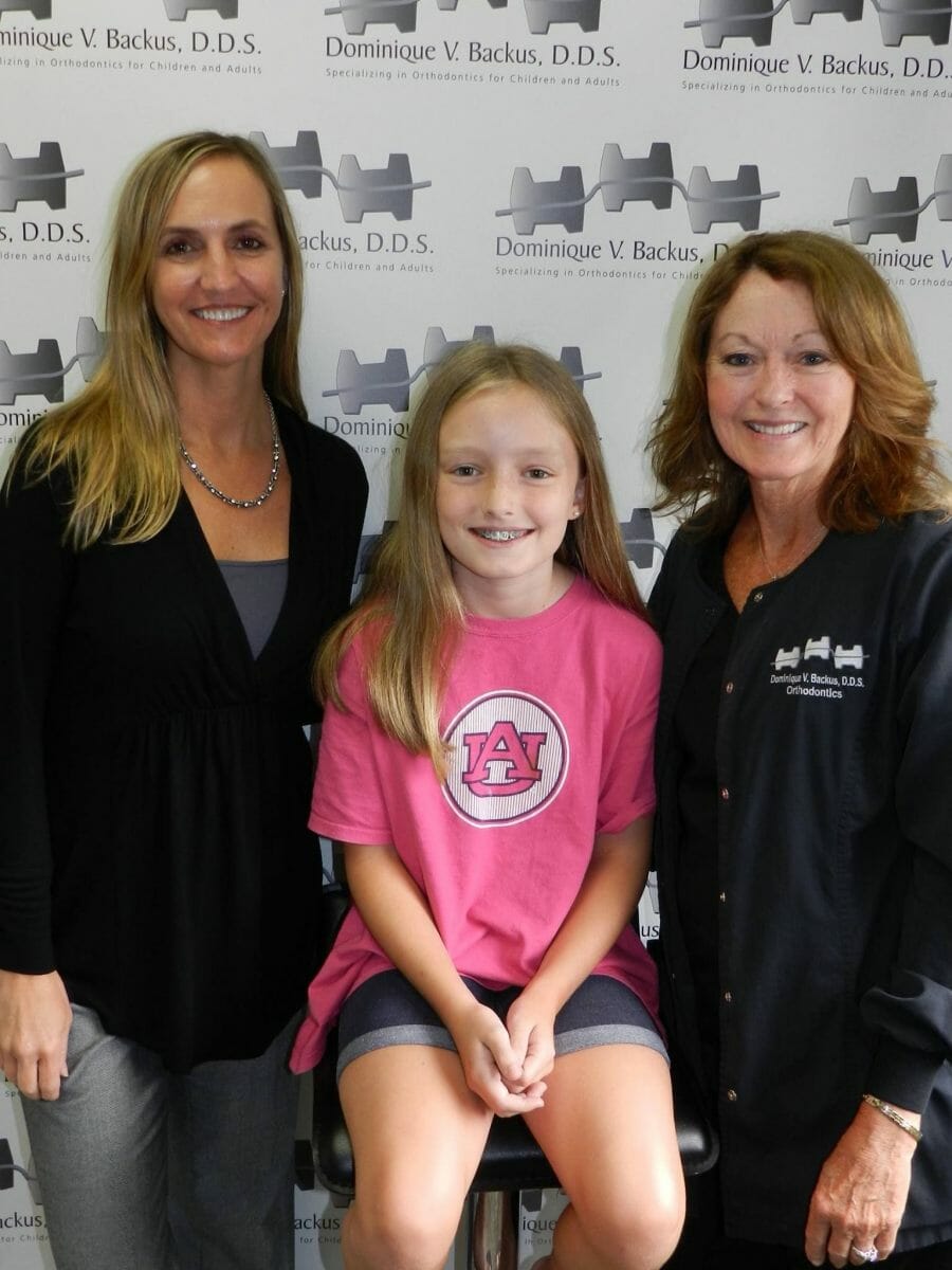 Happy patient with Dr. Backus and a team member after the patient got her braces put on, Backus Smiles
